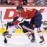 
              Florida Panthers left wing Jonathan Huberdeau (11) takes down Edmonton Oilers center Derek Ryan (10) during the second period of an NHL hockey game, Saturday, Feb. 26, 2022, in Sunrise, Fla. (AP Photo/Wilfredo Lee)
            
