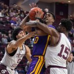 
              LSU guard Brandon Murray (0) tries to drive the lane against Texas A&M forward Henry Coleman III (15) guard Aaron Cash (0) during the first half of an NCAA college basketball game Tuesday, Feb. 8, 2022, in College Station, Texas. (AP Photo/Sam Craft)
            