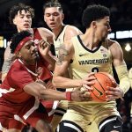 
              Alabama forward Noah Gurley, left, tries to knock the ball away from Vanderbilt guard Scotty Pippen Jr. (2) during the first half of an NCAA college basketball game Tuesday, Feb. 22, 2022, in Nashville, Tenn. (AP Photo/Mark Zaleski)
            