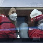 
              Members of Team Switzerland arrive at the Olympic Village ahead of the 2022 Winter Olympics, Tuesday, Feb. 1, 2022, in Beijing. (Anthony Wallace/Pool Photo via AP)
            