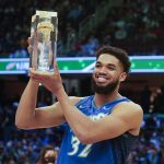 
              Minnesota Timberwolves' Karl-Anthony Towns holds up the trophy after winning the three-point shot part of the skills challenge competition, part of NBA All-Star basketball game weekend, Saturday, Feb. 19, 2022, in Cleveland. (AP Photo/Charles Krupa)
            