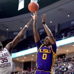 
              LSU guard Brandon Murray (0) makes a three point shot over Texas A&M guard Manny Obaseki (35) during the first half of an NCAA college basketball game Tuesday, Feb. 8, 2022, in College Station, Texas. (AP Photo/Sam Craft)
            