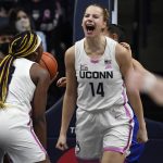 
              Connecticut's Dorka Juhász (14) reacts toward Aaliyah Edwards after making a basket while being fouled during the first half of the team's NCAA college basketball game against DePaul, Friday, Feb. 11, 2022, in Storrs, Conn. (AP Photo/Jessica Hill)
            