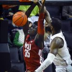 
              Washington State forward Mouhamed Gueye (35) dunks as Oregon center Franck Kepnang (22) tries to defend during the first half of an NCAA college basketball game Monday, Feb. 14, 2022, in Eugene, Ore. (AP Photo/Andy Nelson)
            