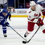 
              Toronto Maple Leafs right wing Ilya Mikheyev (65) tries to stop Carolina Hurricanes right wing Jesper Fast (71) as he takes a shot during the first period of an NHL hockey game in Toronto, Monday, Feb. 7, 2022. (Frank Gunn/The Canadian Press via AP)
            