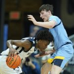 
              Butler's Chuck Harris, left, is defended by Marquette's Tyler Kolek (22) during the second half of an NCAA college basketball game, Saturday, Feb. 12, 2022, in Indianapolis. (AP Photo/Darron Cummings)
            