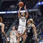 
              Connecticut's Caroline Ducharme (33) shoots over Georgetown's Kaylin West (10) in the first half of an NCAA college basketball game, Sunday, Feb. 20, 2022, in Hartford, Conn. (AP Photo/Jessica Hill)
            