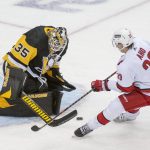
              Pittsburgh Penguins goalie Tristan Jarry, 35, makes a save against Carolina Hurricanes center Sebastian Aho, 20, during the first period of an NHL hockey game against the Carolina Hurricanes and Pittsburgh Penguins on Sunday, Feb. 20, 2022, in Pittsburgh. (AP Photo/Fred Vuich)
            
