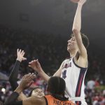 
              Gonzaga center Chet Holmgren, right, shoots between Pacific forward Jeremiah Bailey, left, and guard Alphonso Anderson during the first half of an NCAA college basketball game, Thursday, Feb. 10, 2022, in Spokane, Wash. (AP Photo/Young Kwak)
            