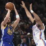 
              Golden State Warriors guard Klay Thompson, left, shoots the ball over Oklahoma City Thunder guard Kenrich Williams in the first half of an NBA basketball game, Monday, Feb. 7, 2022, in Oklahoma City. (AP Photo/Kyle Phillips)
            