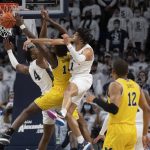 
              Penn State forward Seth Lundy (1) fouls Michigan forward Moussa Diabate (14) during an NCAA college basketball game Tuesday, Feb. 8, 2022 in State College, Pa. (Noah Riffe/Centre Daily Times via AP)
            