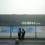 
              Security personnel stand on the sidewalk near Wukesong Sports Centre hockey venue ahead of the 2022 Winter Olympics, Sunday, Jan. 30, 2022, in Beijing. (AP Photo/Jeff Roberson)
            