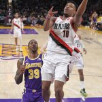 
              Portland Trail Blazers guard Dennis Smith Jr., right, shoots as Los Angeles Lakers center Dwight Howard defends during the first half of an NBA basketball game Wednesday, Feb. 2, 2022, in Los Angeles. (AP Photo/Mark J. Terrill)
            