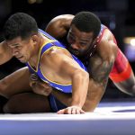 
              Jordan Burroughs, right, of the United States, holds down Nestor Taffur, left, of Colombia, during the Bout at the Ballpark wrestling event Saturday, Feb. 12, 2022, at Globe Life Field in Arlington, Texas. (Steve Nurenberg/The Dallas Morning News via AP)
            