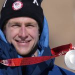 
              Ryan Cochran-Siegle of the United States holds his silver during the medal ceremony for the men's super-G at the 2022 Winter Olympics, Tuesday, Feb. 8, 2022, in the Yanqing district of Beijing. (AP Photo/Luca Bruno)
            