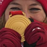 
              Michelle Gisin of Switzerland celebrates winning the gold medal during the medal ceremony for the women's combined at the 2022 Winter Olympics, Thursday, Feb. 17, 2022, in the Yanqing district of Beijing. (AP Photo/Luca Bruno)
            
