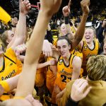 
              Iowa guard Caitlin Clark, center, celebrates with teammates after an NCAA college basketball game against Michigan, Sunday, Feb. 27, 2022, in Iowa City, Iowa. Iowa won 104-80. The victory gave Iowa a share of the Big Ten Conference championship. (AP Photo/Charlie Neibergall)
            