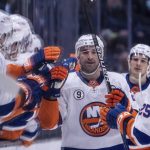 
              New York Islanders forward Kyle Palmieri is congratulated by teammates on the bench after scoring a goal during the first period of the team's NHL hockey game against the Seattle Kraken, Tuesday, Feb. 22, 2022, in Seattle. (AP Photo/Stephen Brashear)
            