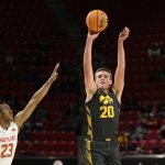 
              Iowa guard Payton Sandfort (20) shoots against Maryland guard Ian Martinez (23) during the first half of an NCAA college basketball game, Thursday, Feb. 10, 2022, in College Park, Md. (AP Photo/Nick Wass)
            