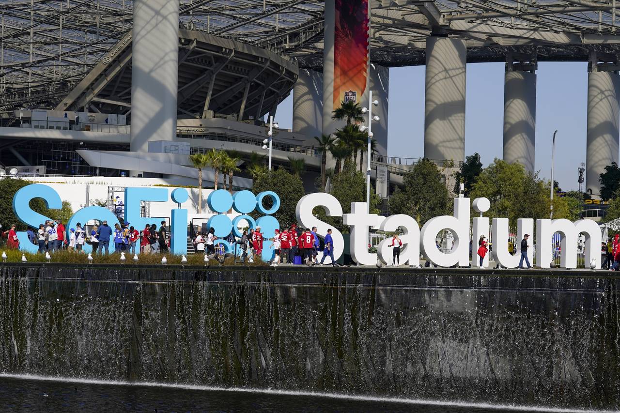 FILE - Fans make their way to SoFi Stadium before the NFC Championship NFL football game between th...