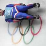 
              Marian Skupek of Slovakia speeds past the Olympic rings during a men's luge training run at the 2022 Winter Olympics, Wednesday, Feb. 2, 2022, in the Yanqing district of Beijing. (AP Photo/Mark Schiefelbein)
            