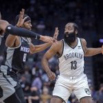 
              Brooklyn Nets guard James Harden (13) is double-teamed by Sacramento Kings forward Maurice Harkless (8) and center Richaun Holmes (22) during the first quarter of an NBA basketball game in Sacramento, Calif., Wednesday, Feb. 2, 2022. (AP Photo/José Luis Villegas)
            