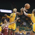 
              Baylor guard Sarah Andrews, center, and teammate Caitlin Bickle, right, reach for the ball while Oklahoma guard Nevaeh Tot, left, watches during the first half of an NCAA college basketball game Wednesday, Feb. 2, 2022, in Waco, Texas. (Rod Aydelotte/Waco Tribune-Herald via AP)
            