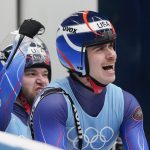 
              Zachary Di Gregorio and Sean Hollander, of the United States, celebrate in the finish area after the luge doubles run 2 at the 2022 Winter Olympics, Wednesday, Feb. 9, 2022, in the Yanqing district of Beijing. (AP Photo/Mark Schiefelbein)
            