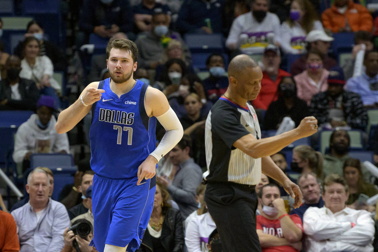 Dallas Mavericks guard Luka Doncic (77) points to the crowd after a score during the second half of...