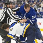 
              Toronto Maple Leafs' Michael Bunting, right, fights with St. Louis Blues' Torey Krug during second-period NHL hockey game action in Toronto, Saturday, Feb. 19, 2022. (Chris Young/The Canadian Press via AP)
            