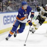 
              New York Islanders defenseman Noah Dobson (8) is pursued by Boston Bruins center Trent Frederic (11) during the first period of an NHL hockey game Thursday Feb. 17, 2022, in Elmont, N.Y. (AP Photo/Corey Sipkin).
            