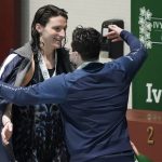 
              Pennsylvania's Lia Thomas, left, gets a hug from Yale's Iszak Henig following the medal ceremony after Thomas won the 100-yard freestyle and Henig finished second at the Ivy League women's swimming and diving championships at Harvard, Saturday, Feb. 19, 2022, in Cambridge, Mass. Henig, who is transitioning to male but hasn't begun hormone treatments yet, is swimming for the Yale women's team and Thomas, who is transitioning to female, is swimming for the Penn women's team. (AP Photo/Mary Schwalm)
            