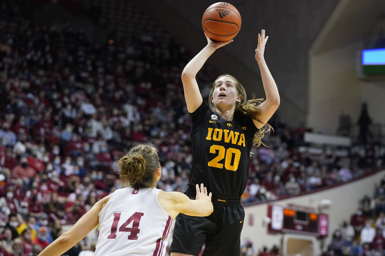 Iowa's Kate Martin (20) shoots over Indiana's Ali Patberg (14) during the first half of an NCAA col...