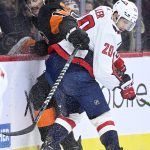 
              Philadelphia Flyers' Zack MacEwen, left, is checked into the boards by Washington Capitals' Lars Eller during the second period of an NHL hockey game, Saturday, Feb. 26, 2022, in Philadelphia. (AP Photo/Derik Hamilton)
            