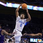 
              UCLA guard Jaylen Clark (0) goes up for a dunk past Washington guard Terrell Brown Jr. (23) and guard Jamal Bey (5) during the second half of an NCAA college basketball game Saturday, Feb. 19, 2022, in Los Angeles. (AP Photo/Marcio Jose Sanchez)
            