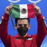 
              Donovan Carrillo, of Mexico, gestures after competing in the men's free skate program during the figure skating event at the 2022 Winter Olympics, Thursday, Feb. 10, 2022, in Beijing. (AP Photo/David J. Phillip)
            