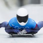 
              Kelly Curtis, of United States, finishes the women's skeleton run 2 at the 2022 Winter Olympics, Friday, Feb. 11, 2022, in the Yanqing district of Beijing. (AP Photo/Mark Schiefelbein)
            