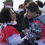 
              Gold medal winner Japan's Ayumu Hirano, left, is congratulated by United States' Shaun White after the men's halfpipe finals at the 2022 Winter Olympics, Friday, Feb. 11, 2022, in Zhangjiakou, China. (AP Photo/Gregory Bull)
            