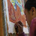 
              A woman paints a thangka, a Tibetan Buddhist painting, in Tongren, in southwestern China's Sichuan province on Sunday, Sept. 18, 2020. Ahead of the Beijing summer Olympics 14 years ago, Tibet was on fire. Deadly clashes between Tibetans and security forces in Lhasa made global headlines, and for weeks, monks and herders battled bullets and batons.  But today, Tibet has fallen silent, even as the Olympic games come to Beijing for a second time.(AP Photo/Dake Kang)
            