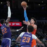 
              Oklahoma City Thunder forward Isaiah Roby, right, shoots in front of Phoenix Suns center Deandre Ayton (22) and forward Cameron Johnson (23) in the first half of an NBA basketball game Thursday, Feb. 24, 2022, in Oklahoma City. (AP Photo/Sue Ogrocki)
            