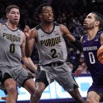 
              Northwestern guard Boo Buie, right, drives to the basket against Purdue forward Mason Gillis, left, and guard Eric Hunter Jr. during the second half of an NCAA college basketball game in Evanston, Ill., Wednesday, Feb. 16, 2022. Purdue won 70-64. (AP Photo/Nam Y. Huh)
            