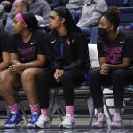 
              DePaul's Sonya Morris, center, sits on the bench with teammates during the first half of an NCAA college basketball game against Connecticut, Friday, Feb. 11, 2022, in Storrs, Conn. (AP Photo/Jessica Hill)
            