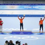 
              Ireen Wust of the Netherlands, center, reacts during a flower ceremony after winning the gold medal and setting an Olympic record in the women's speedskating 1,500-meter race at the 2022 Winter Olympics, Monday, Feb. 7, 2022, in Beijing. Left is silver medalist Miho Takagi of Japan and right is bronze medalist Antoinette de Jong of the Netherlands. (AP Photo/Ashley Landis)
            