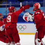 
              Russian Olympic Committee goalkeeper Ivan Fedotov (28) celebrates with Nikita Nesterov (89) and Yegor Yakovlev (44) after Russian Olympic Committee defeated Sweden in a shootout during a men's semifinal hockey game at the 2022 Winter Olympics, Friday, Feb. 18, 2022, in Beijing. (AP Photo/Matt Slocum)
            