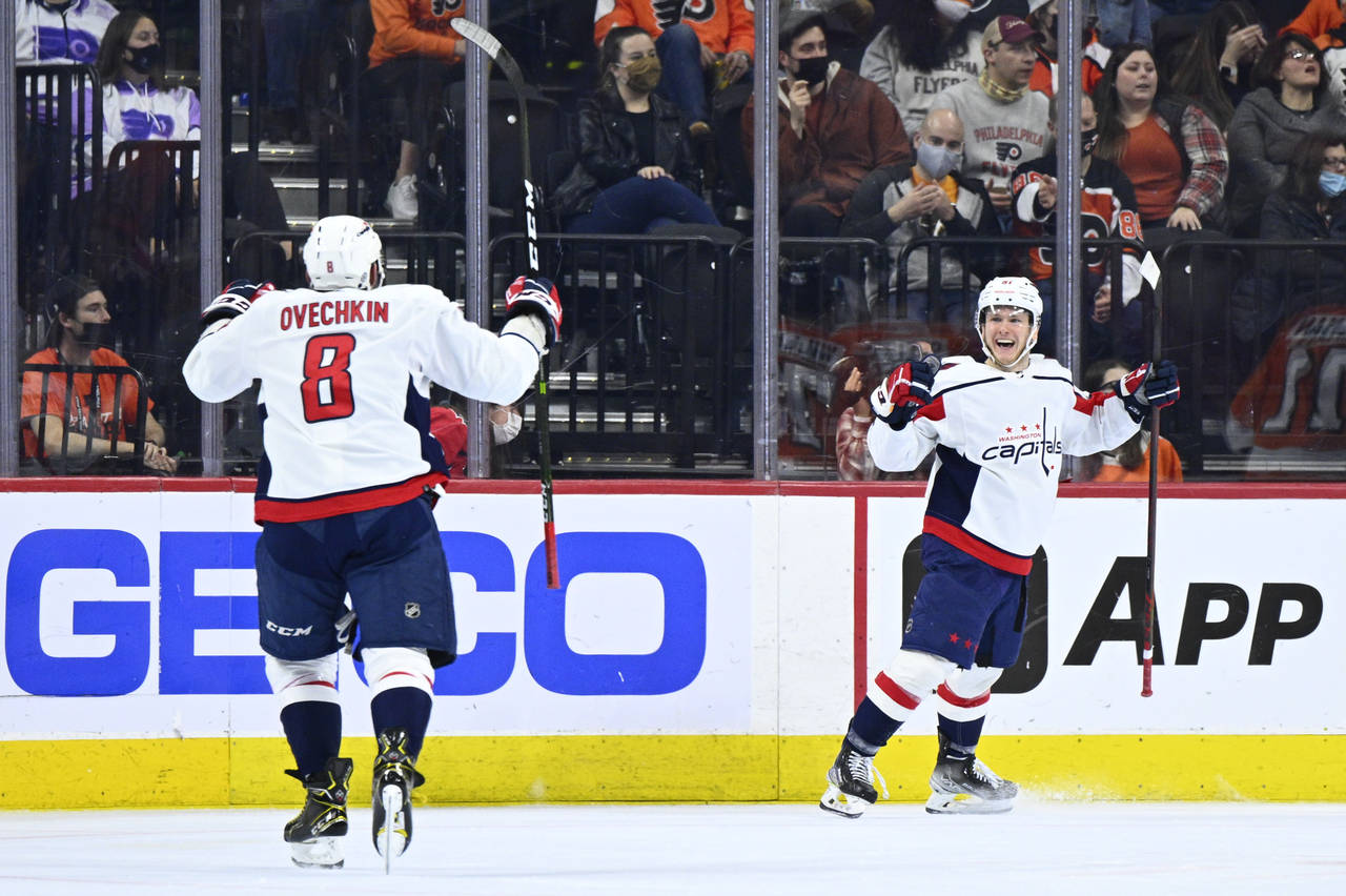 Washington Capitals' Joe Snively, right, celebrates with Alex Ovechkin (8) after scoring a goal dur...