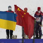 
              From left silver medal winner Ukraine's Oleksandr Abramenko, gold medal winner China's Qi Guangpu and bronze medal winner Ilia Burov, of the Russian Olympic Committee, celebrate during the venue award ceremony for the men's aerials at the 2022 Winter Olympics, Wednesday, Feb. 16, 2022, in Zhangjiakou, China. (AP Photo/Lee Jin-man)
            