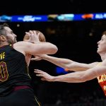 
              Cleveland Cavaliers forward Kevin Love (0) tries to get a shot off as Atlanta Hawks guard Kevin Huerter (3) defends during the second half of an NBA basketball game Tuesday, Feb. 15, 2022, in Atlanta. (AP Photo/John Bazemore)
            