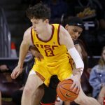 
              Pacific guard Jaden Byers, back, tries to steal the ball away from Southern California guard Drew Peterson (13) during the first half of an NCAA college basketball game Tuesday, Feb. 8, 2022, in Los Angeles. (AP Photo/Ringo H.W. Chiu)
            