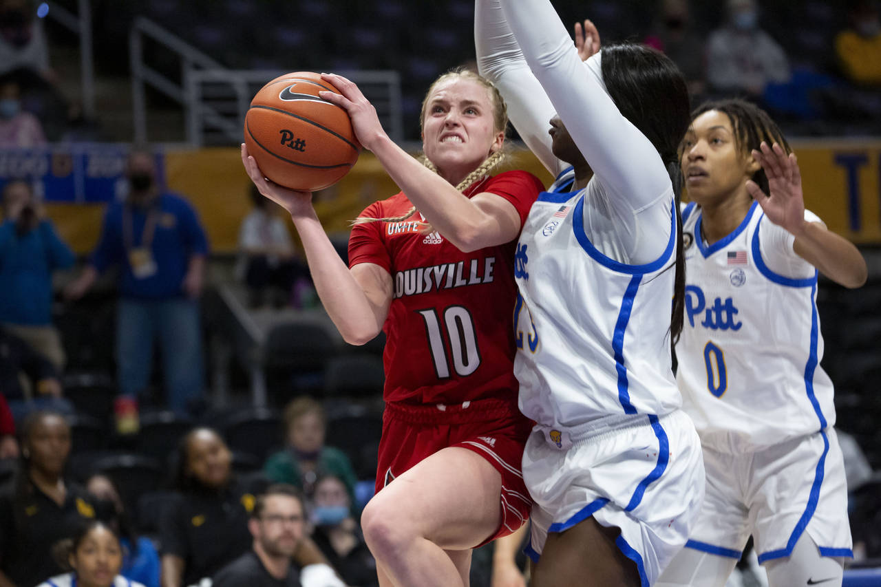 Louisville's Hailey Van Lith (10) drives to the hoop as she is guarded by Pittsburgh's Rita Igbokwe...