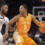 
              Tennessee guard Zakai Zeigler (5) dribbles the ball against South Carolina guard James Reese V (0) during the first half of an NCAA college basketball game Saturday, Feb. 5, 2022, in Columbia, S.C. (AP Photo/Sean Rayford)
            